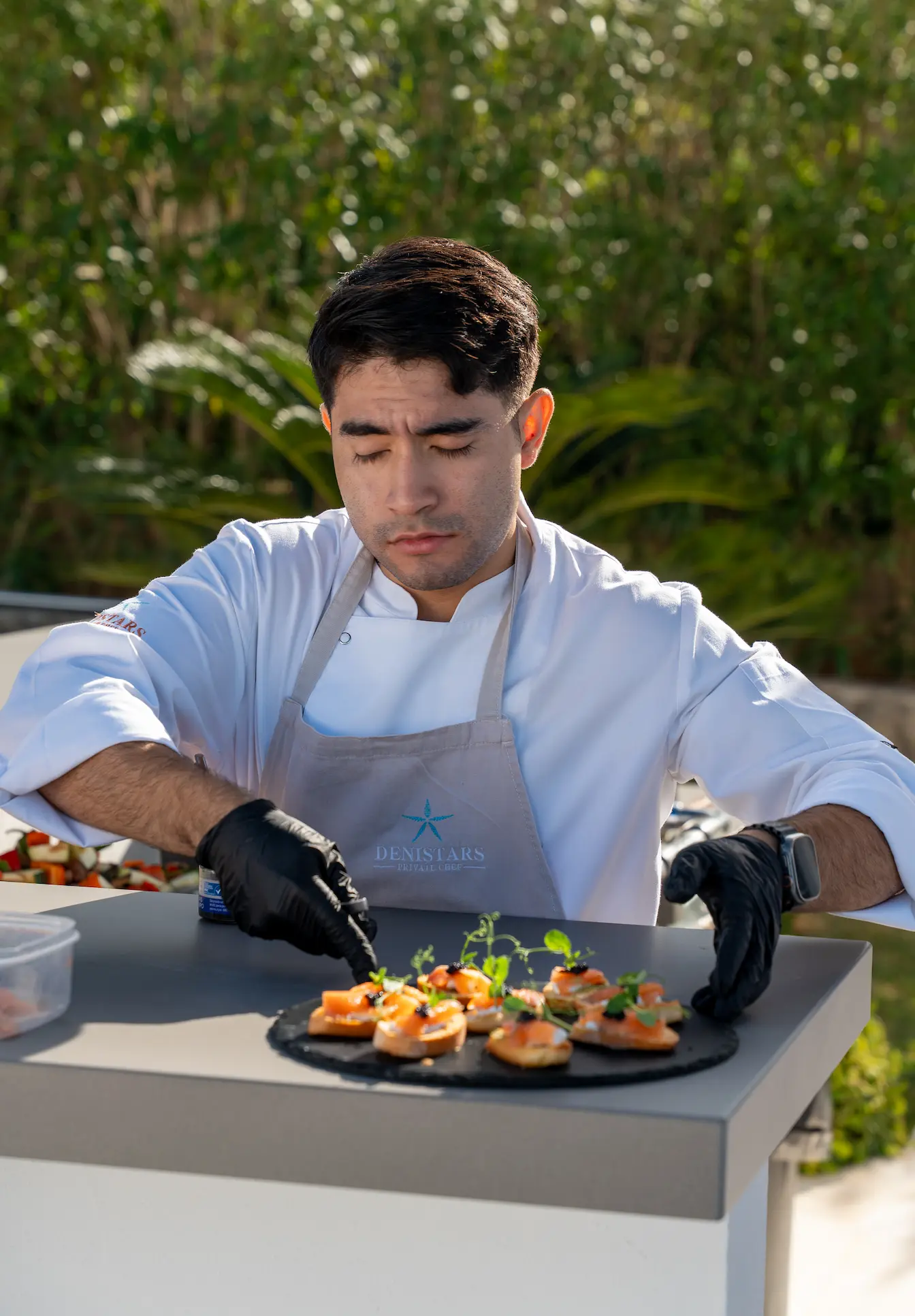 Private chef plating gourmet appetizers with precision
